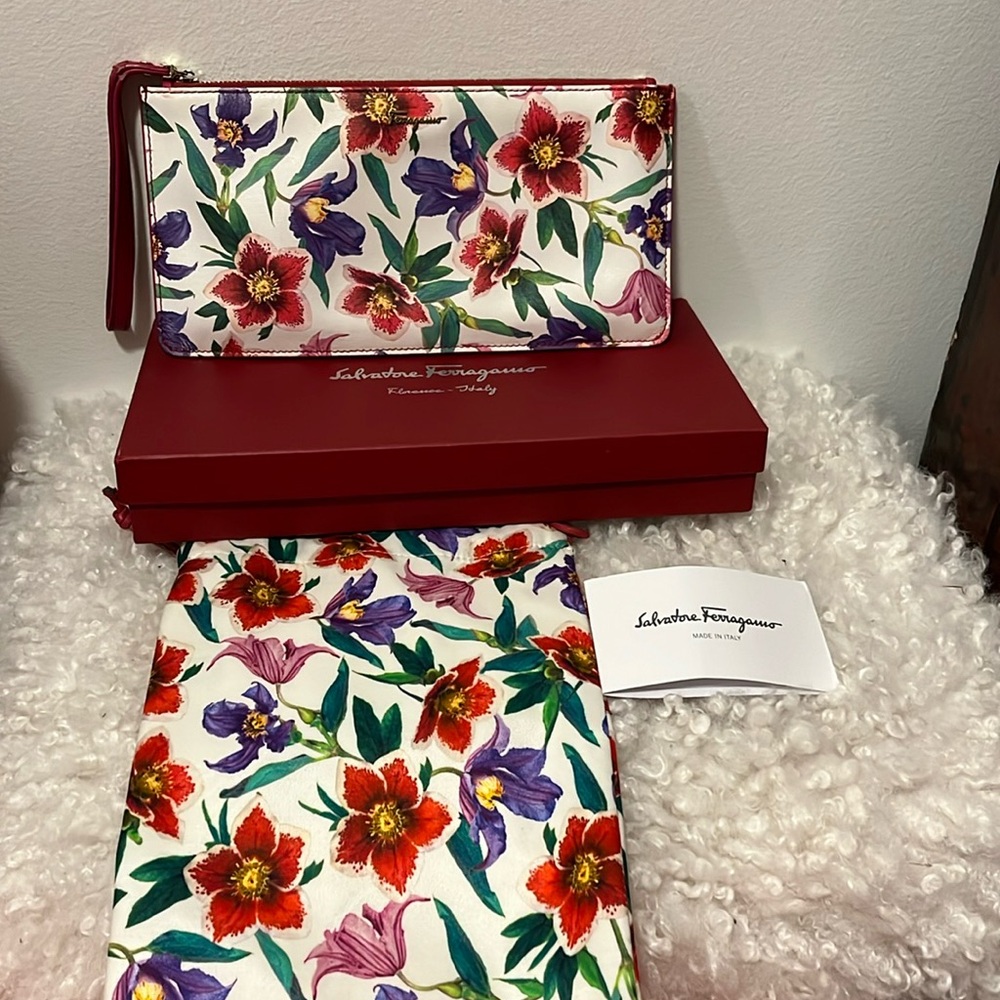 Authentic Ferragamo wristlet. Good condition. Marks on inside and outside of bag